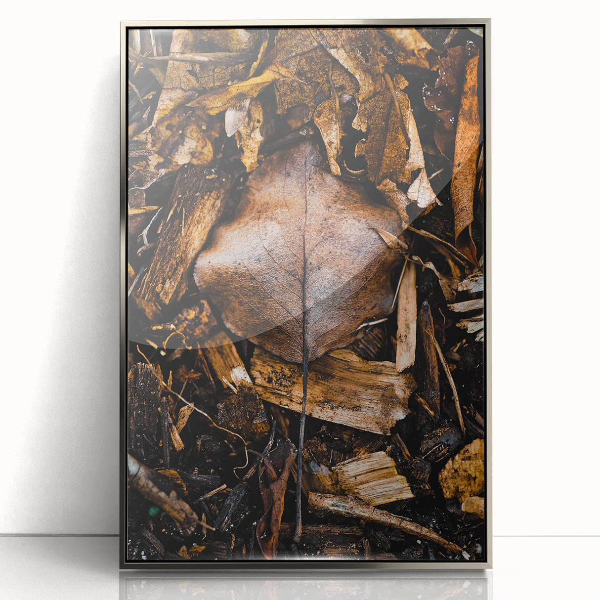 Mid-century modernist art depicting fall scenery in muted orange and brown tones, framed in silver acrylic.