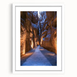 Framed landscape artwork depicting a serene cave scene, featuring earthy tones and a white mat border, ideal for enhancing home decor aesthetics.