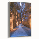 Framed canvas artwork showcasing a stunning landscape with intricate cave formations, highlighted by a sleek silver frame, perfect for modern home decor.