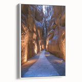 Framed canvas artwork depicting a serene landscape with caves, presented in a sleek white frame. Ideal for enhancing modern home decor with its earthy tones and artistic details.