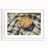 Abstract art print of assorted pastries in soft pastel tones, displayed in a white frame with mat.