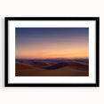 Desert landscape framed art print with a black mat, showcasing vibrant orange and yellow hues of a sunset over sand dunes, ideal for modern home decor.