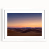 Desert landscape framed artwork showcasing vibrant hues of orange and yellow, with a white mat border, perfect for modern home decor. Ideal for adding a serene touch to any room.