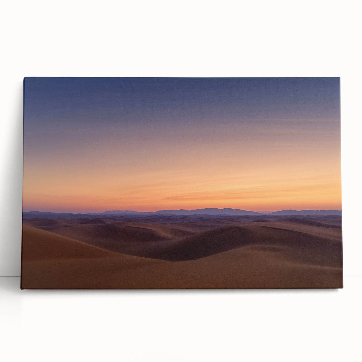 Stretched canvas artwork depicting a serene desert landscape at sunset, showcasing vibrant orange and purple hues with cacti silhouettes, ideal for home decor.
