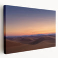 Stretched canvas artwork depicting a vibrant desert landscape in warm tones, showcasing rolling sand dunes under a bright blue sky, ideal for home decor.