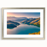 Textured abstract art print of a European scenery in muted earth tones, framed in silver, suitable for bedroom decor.