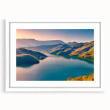 Abstract art print of a European Albanian scenery in muted earth tones, framed in white, ideal for dining room decor.