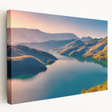 Landscape painting of a European countryside on stretched canvas, featuring soft green and earth tones.