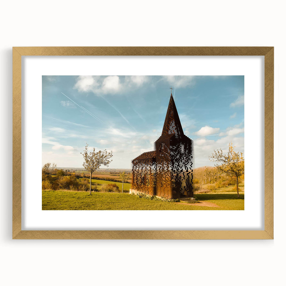 Abstract art print of a European cityscape in muted gold and brown tones, framed with a gold mat.