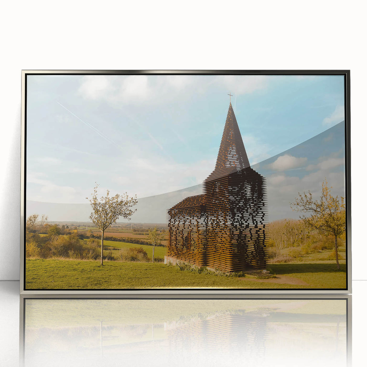 Large art print of a European Belgian landscape in muted green and blue tones, framed in silver acrylic.