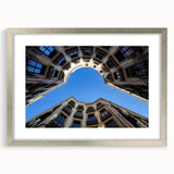 Extra large abstract art print depicting a textured Barcelona scenery in muted earth tones, framed in silver.