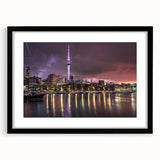 Abstract art print of Auckland skyline in vibrant colors on a textured, extra large canvas, framed in black.