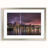 Textured abstract art print depicting Auckland skyline in cool silver and blue tones on a framed canvas.