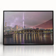 Large abstract wall art depicting Auckland's skyline in muted gray and blue tones, framed in black acrylic.