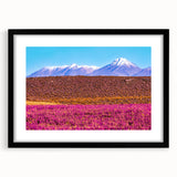 Extra large abstract art print depicting a colorful, textured scenery of Bolivia, in a black frame with mat.