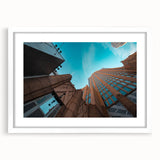 Abstract art print of Charlotte skyline in muted gray and blue tones on a white framed canvas.