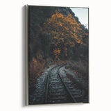 Framed canvas featuring a vintage landscape painting of an autumnal forest with colorful foliage and a black background.