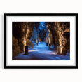 Framed landscape artwork depicting a serene cave scene, featuring a sleek black frame with a white mat, ideal for modern home decor. This piece enhances any room with its captivating natural beauty and elegant presentation.