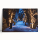 Stretched canvas artwork depicting a serene landscape with caves, featuring rich earthy tones and textured details, perfect for nature-inspired home decor.