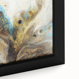 Close-up of a framed abstract art canvas displaying vibrant splatters of blue, yellow, and red paint on a textured surface, perfect for modern decor.