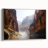 Framed canvas artwork depicting a stunning landscape of canyons, showcasing intricate details and rich colors. The piece is elegantly bordered with a silver frame, enhancing its visual appeal. Perfect for nature enthusiasts and modern decor.
