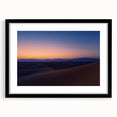 Desert landscape artwork framed in a sleek black mat, showcasing vibrant hues of orange and yellow, ideal for modern home decor. Perfect for nature lovers.