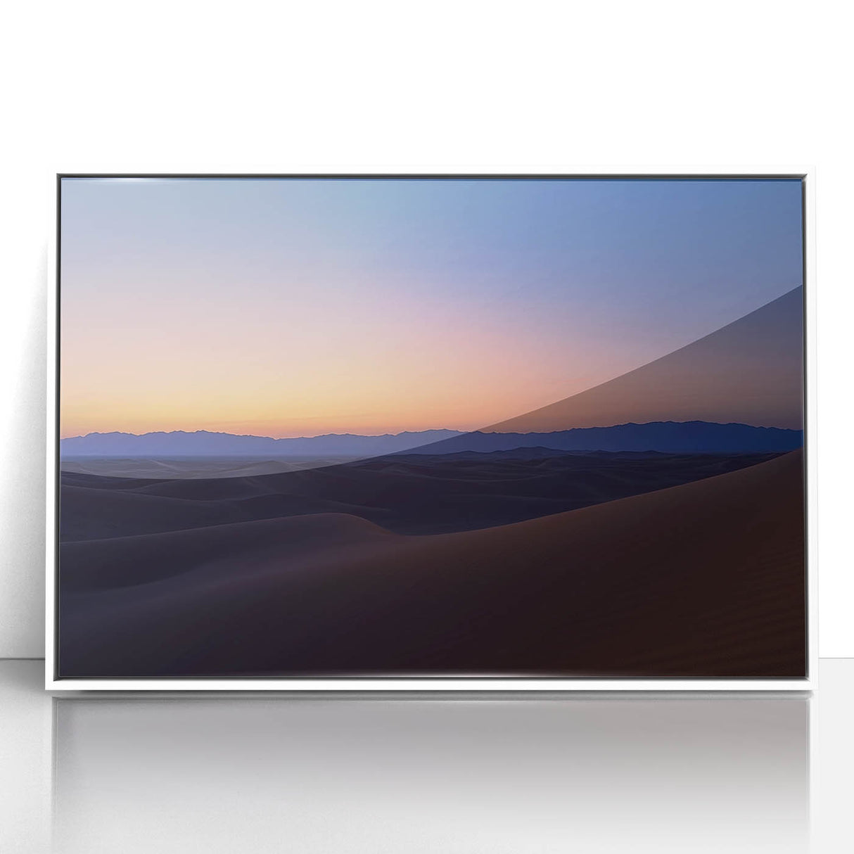 Framed acrylic artwork showcasing a vibrant desert landscape with warm tones of orange and yellow, set in a sleek white frame, perfect for modern décor.