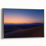 Framed canvas artwork showcasing a desert landscape design with a silver frame, highlighting warm tones and intricate details, perfect for home decor or office styling.