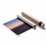 Desert landscape rolled print showcasing vibrant hues of orange and gold, capturing a serene sunset over sandy dunes, elegantly packaged in a protective tube.