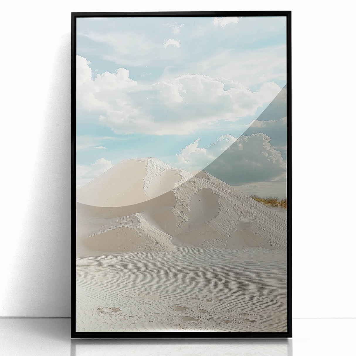Framed acrylic artwork showcasing a serene desert landscape with golden sand dunes and a clear blue sky, presented in a sleek black frame, perfect for modern decor.