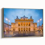 Framed canvas featuring a vintage landscape painting of a European scene in muted gold and black tones.