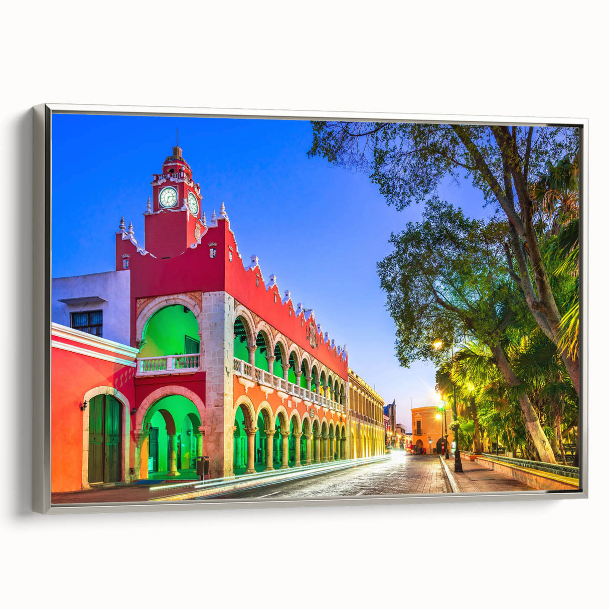 Vintage poster art of Yucatán scenery on a silver-framed canvas, featuring colorful art against a black background.