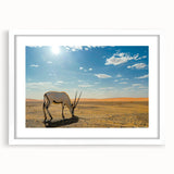 Abstract art print depicting a Middle Eastern desert scene in muted earth tones, framed with a white mat.