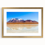 Extra large abstract art print of a textured South American scenery in muted earth tones, framed in gold.