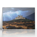 Framed acrylic artwork depicting a scenic landscape with a majestic castle, set against a vibrant backdrop of mountains and blue skies, perfect for home decor.