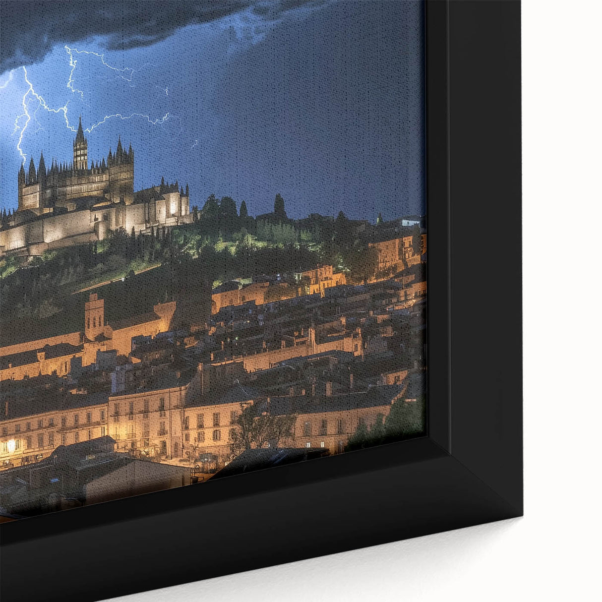 Close-up of a framed canvas showcasing a vibrant landscape painting of a majestic castle surrounded by lush greenery and a clear blue sky, perfect for home decor.