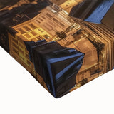 Close-up of a stretched canvas depicting a vibrant landscape scene featuring a majestic castle surrounded by lush greenery under a clear blue sky, perfect for home decor.