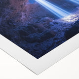 Rolled canvas showcasing a vibrant landscape scene with caves, featuring rich colors and intricate details, presented in a protective cardboard tube for safe shipping.