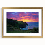 Elegant gold-framed landscape artwork depicting dramatic cliffs and serene ocean waves, complemented by a white mat, perfect for home decor and art enthusiasts.
