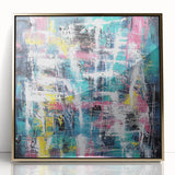 Framed abstract art piece showcasing vibrant gold and colorful splatters on a sleek acrylic surface, perfect for modern home decor and artistic flair.