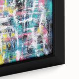 Close-up view of a vibrant abstract splatter design on a framed canvas, showcasing bold colors and dynamic patterns, perfect for modern home decor enhancement.