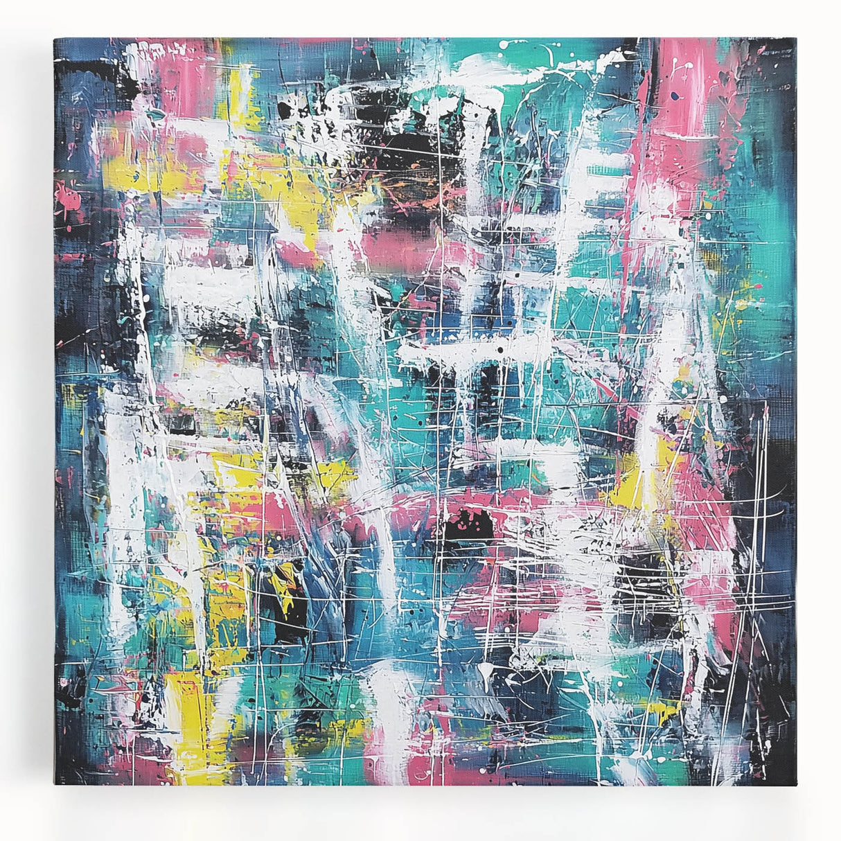 Abstract splatter design on stretched canvas showcasing vibrant colors of blue, pink, and yellow, perfect for modern home decor or art enthusiasts.