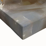 Close-up of a large art canvas featuring a black and white landscape painting of pastries, ideal for bedroom wall decor.