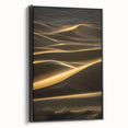 Framed canvas wall art showcasing a serene desert landscape with rolling dunes in warm beige and gold tones, featuring a sleek black frame, perfect for modern decor.