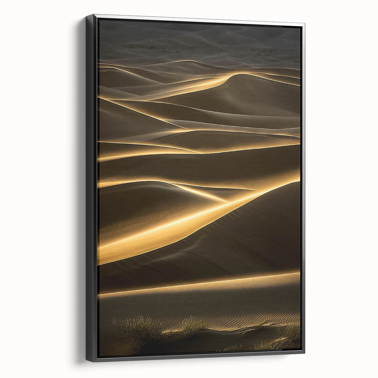 Framed canvas wall art showcasing a serene desert landscape with rolling dunes in warm beige and gold tones, featuring a sleek black frame, perfect for modern decor.
