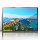 Large art print of a serene Austrian landscape in muted greens and blues on silver-framed acrylic.