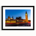 Colorful abstract art print of London scenery in vibrant hues on textured canvas, framed in black.