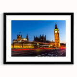 Colorful abstract art print of London scenery in vibrant hues on textured canvas, framed in black.