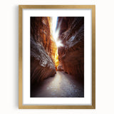 Elegant gold-framed landscape artwork featuring a serene cave scene, complete with a white mat, enhancing the visual depth and sophistication of home decor.