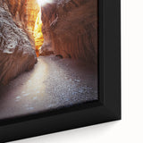 Close-up of a framed canvas artwork depicting vibrant landscapes and caves, showcasing intricate details and textures ideal for home decor in earthy tones.